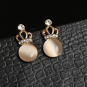 Elegant gold crown earrings with cat eye stone and sparkling crystals on black display