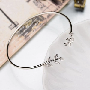 Detailed macro view of adjustable silver leaf bracelet with textured metallic leaf design