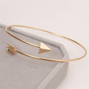 Polished gold arrow open cuff bracelet featuring minimalist arrow tip and feather design