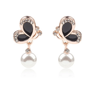 Detail of butterfly drop earrings with black enamel wings and hanging white pearl