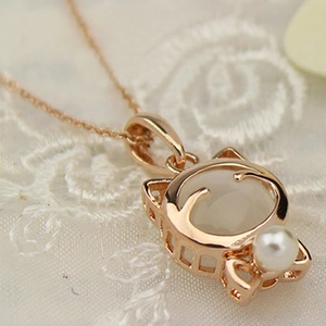 Elegante roségoldene Katzenkette mit weißem Opal und Perle auf weißer Spitze