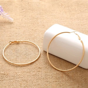 Chic polished gold hoop earrings for women featuring a large circular minimalist design