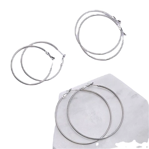 Three pairs of classic silver hoop earrings with minimalist polished metal texture