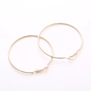 Minimalist large golden hoop earrings for women with smooth metallic polished finish