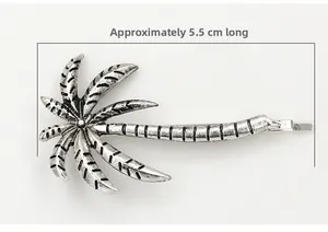 Detail showing a 5.5cm vintage silver palm tree hair clip with realistic leaf texture