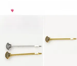 Close-up of shell-shaped metal hair clips in vintage gold and silver alloy finishes