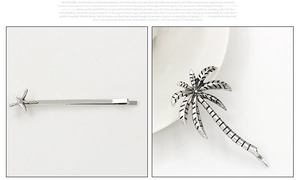 Detailed macro view of vintage silver starfish and palm tree alloy hair clip accessories
