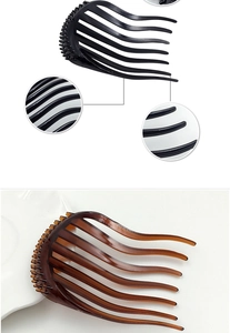 Detail view of curved hair forks in black and amber resin for volume styling and buns
