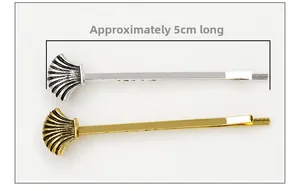 Close-up of golden and silver shell-shaped alloy hair clips with 5cm length detail
