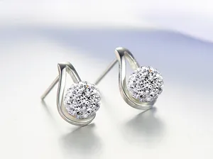 Macro view of teardrop hollow frame with crystal pave ball stud earring in silver finish