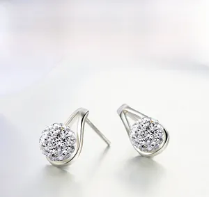 Detailed view of silver stud earrings with rhinestone disco balls in teardrop frames