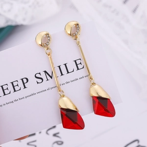 Elegant gold drop earrings with long metal link and faceted red crystal pendant