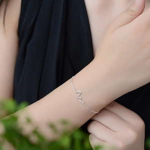 Minimalist silver heartbeat line bracelet for women featuring an elegant ECG wave design