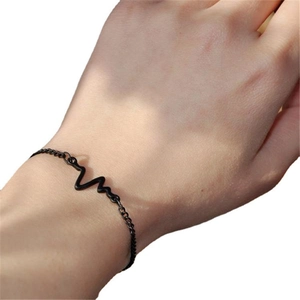 Minimalist black heart rate pulse waveform bracelet on wrist with thin metal chain link
