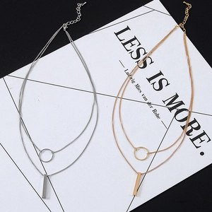 Double-layered gold and silver geometric necklace with circle and bar pendant charms