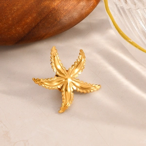 Exquisite 18K gold plated starfish brooch with 3D texture on marble surface