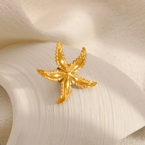 Macro shot of 18k gold plated starfish brooch featuring realistic textured surface details