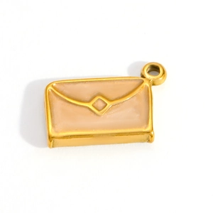 Macro view of gold plated stainless steel envelope pendant with cream enamel detailing