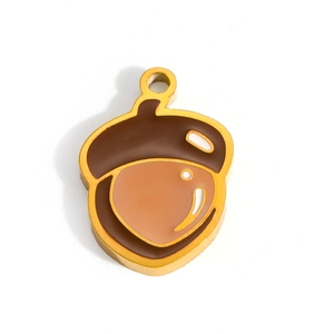 Detailed macro view of 18K gold plated acorn pendant with brown enamel finish