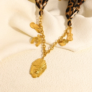 Leopard print fabric and gold chain necklace with western cowboy style charms