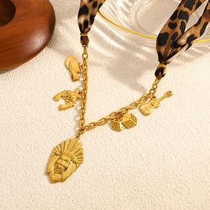 Detailed close-up of Bohemian gold-plated necklace with leopard scarf and western charms
