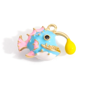 Detail view of a cute pufferfish charm with colorful enamel and gold finish for DIY necklaces