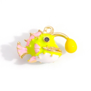 Detail of yellow and pink pufferfish enamel charm with a golden alloy metal base