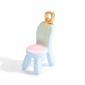 Detailed close-up of a blue and pink enamel chair charm with gold plating for DIY jewelry