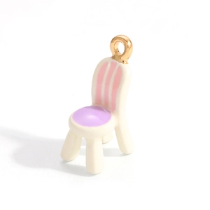 Detailed macro view of a chair-shaped alloy pendant with pastel enamel drip finish