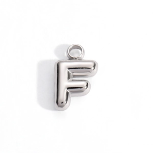Macro detail of a 3D puffed letter F pendant in polished silver stainless steel finish