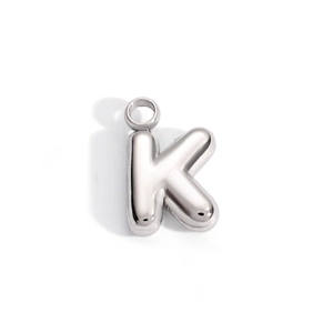 Macro view of 3D bubble style letter K pendant with high-polished silver mirror finish