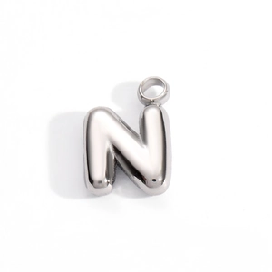 Detailed close-up of a silver stainless steel letter N bubble pendant with polished finish