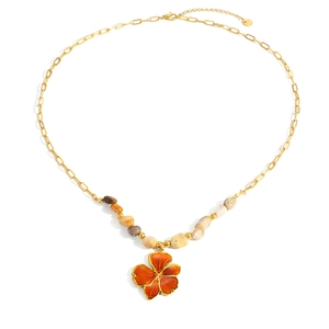 Detailed view of the flower pendant and natural stones on the gold link necklace