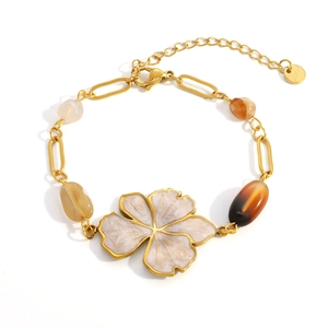 Macro shot of gold stainless steel necklace with marble flower pendant and natural beads