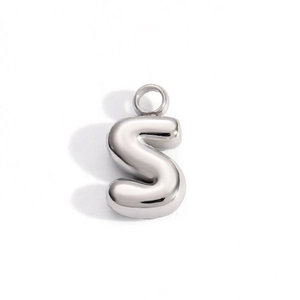 Close-up of polished silver bubble letter S pendant with a reflective 3D balloon design