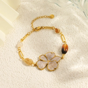 Detailed shot of 18K gold plated flower necklace with purple enamel and natural stones