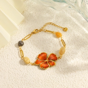 Detailed close-up of retro floral necklace with orange petals and natural stone beads