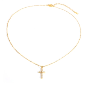 Detailed view of a gold plated cross pendant with shimmering inlaid crystals and chain