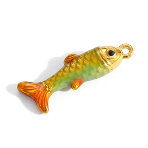 Macro detail of fish-shaped pendant with yellow-green enamel and golden scales