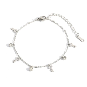 Detailed macro view of silver stainless steel chain with key charms and zircon stones