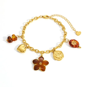 Stainless steel gold bracelet with amber flower and heart charms in a vintage style