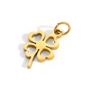 Detail shot of a golden hollow heart clover pendant with a polished jumping ring