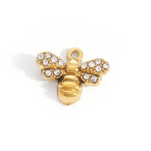 Macro shot of gold bee pendant accessory with sparkling white zircon wings and fine details