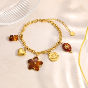 Vintage stainless steel gold bracelet with amber resin flower and heart charms