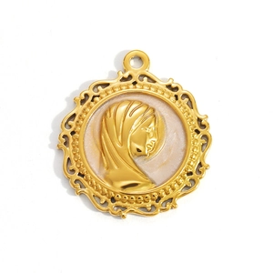 Detailed macro view of a golden vintage pendant with a white shell female relief portrait