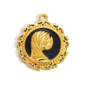 Macro detail of vintage gold pendant with black enamel and female profile relief