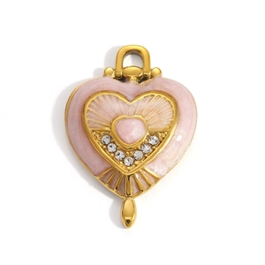 Detail of vintage heart pendant with pink enamel inlay and sparkling rhinestones