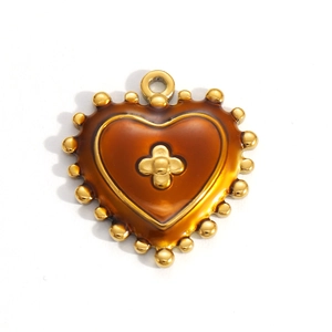 Detailed macro view of golden heart pendant with amber resin and star relief