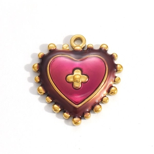 Detailed macro view of heart-shaped enamel pendant with gold border and floral motif