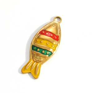 Macro detail of a fish pendant with colorful enamel stripes and gold plating